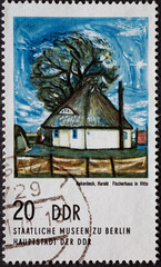GERMANY, DDR - CIRCA 1974 : a postage stamp from Germany, GDR showing a thatched fisherman's house...