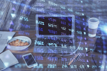 Double exposure of graph and financial info and work space with computer background. Concept of international online trading.