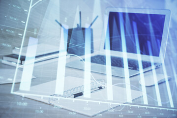Obraz premium Forex graph hologram on table with computer background. Multi exposure. Concept of financial markets.