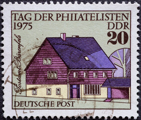 GERMANY, DDR - CIRCA 1975 : a postage stamp from Germany, GDR showing the new post office Bärenfels (Eastern Ore Mountains). Philatelist Day