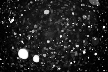 Abstract Background Defocus Light Spots on a black background.