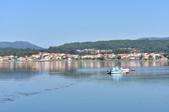 Coastal village with blue sky and water reflections. Noia or Noya, Rias Baixas, Coru&ntilde;a, Galicia, Spain.
