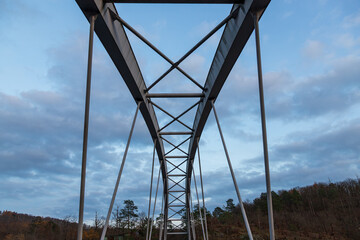 Arch structure of an iron bridge near Veveri Castle near Brno in the Czech Republic. The blue sky is in the background.