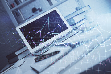 Financial graph colorful drawing and table with computer on background. Double exposure. Concept of...