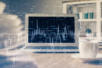 Financial chart drawing and table with computer on background. Multi exposure. Concept of...