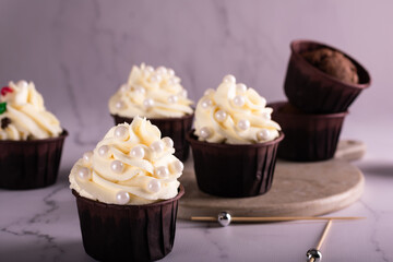 Chocolate cupcakes decorated with vanilla cream