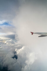 Fototapeta na wymiar Beautiful cloudy from plane with view of wing 