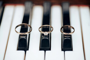 close up of piano keys and wedding rings