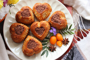 Heart shaped cookies decorated with grated chocolate and tangerines