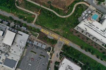 "Black Lives Matter" Written on the Atlanta Beltline in Yellow Letters - Atlanta, GA, Aerial View