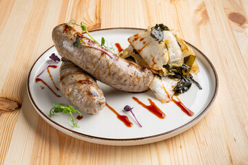 Fried Weisswurst (white veal sausage) with marinated cabbage and sea wed