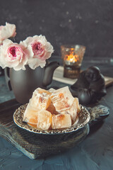 Turkish tea and Turkish delight in still life with candles. Traditional Turkish sweets on the table