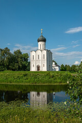 Fototapeta na wymiar Church of the Intercession of the most Holy Theotokos on the Nerl in summer. Built in the 12th century. Bogolyubovo, Vladimir region, tourist Golden ring of Russia. Historical sights of Russia