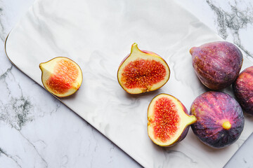Top view of fresh figs, whole and cut on slices