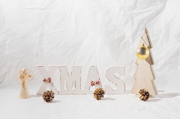 Christmas background with wooden letters, pine cone and ball