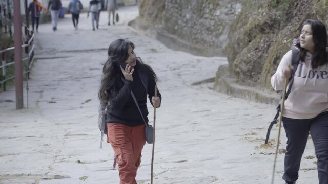 Indian girls trekking Kedarnath Temple, Uttarakhand India, tired. High quality 4k footage