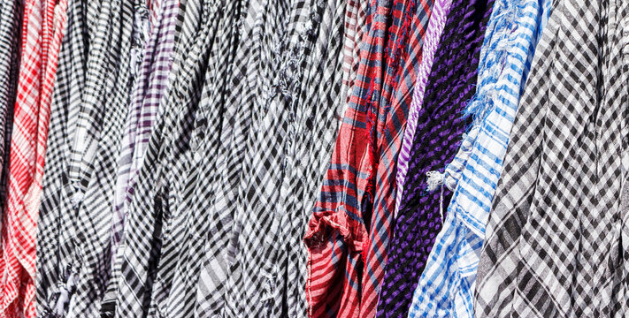 Traditional Keffiyeh or kefia hanging on hangers on bazaar in Egypt