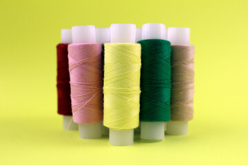 Lemon yellow background with threads in the foreground