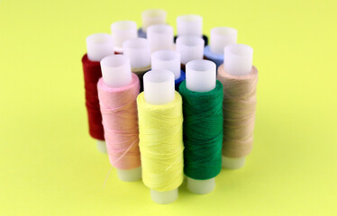 Lemon yellow background with threads in the foreground
