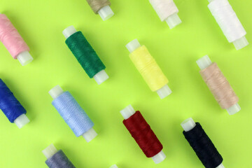 Multicolored threads on a light green background