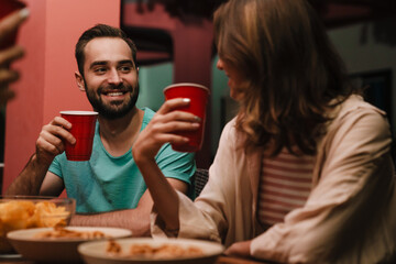 Group of young friends drinking and laughing