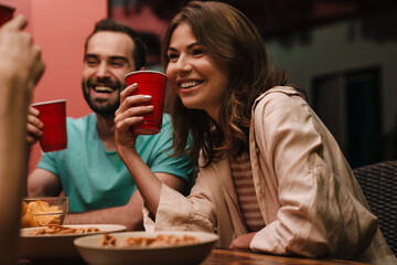 Group of young friends drinking and laughing