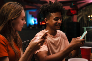 pGroup of happy smiling friends with smartphones