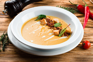 Pumpkin soup on wooden background