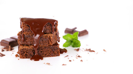 chocolate sauce pouring on stack of chocolate cake isolated on white background