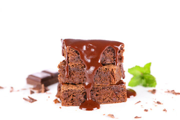 chocolate sauce pouring on stack of chocolate cake isolated on white background