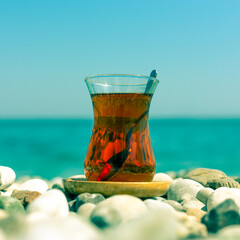 Armudu. Tea in a glass on the beach.