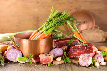 preparation of french traditional pot au feu or beef stew broth, soup and vegetables