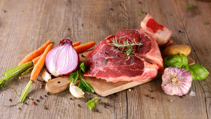 raw beef and vegetable on wooden board