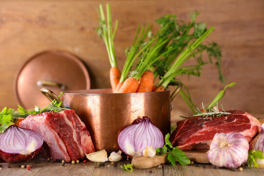 preparation of french traditional pot au feu or beef stew broth, soup and vegetables