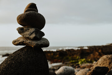 stones on the beach. Mountain of stones on the beach symbolizing spiritual balance. Dangerous fashion for the environment