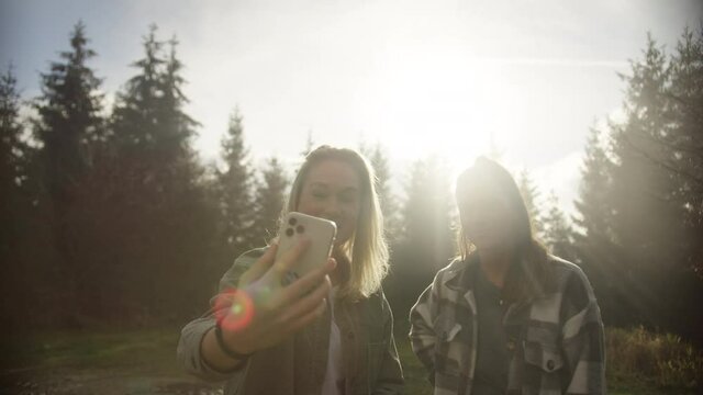 social media Influencer vlogging in the mountains. two girls Hiking and vlog outdoor nature forest