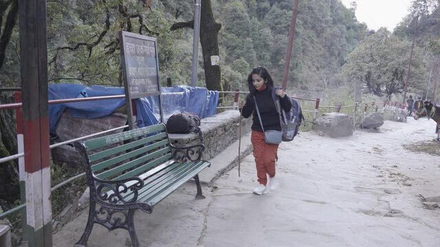 Indian girl trekking Kedarnath Temple, Uttarakhand India, tired. High quality 4k footage
