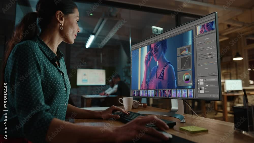 Poster Middle Aged Multiethnic Specialist Working on Desktop Computer in Creative Office Environment. Beautiful Diverse Female is Editing a Fashion Photograph with Model in Digital Graphics Editing Software.