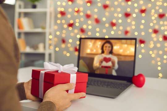 Happy couple in love showing each other Valentine presents on romantic virtual date