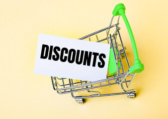 The card with the words DISCOUNTS is in the shopping cart. Marketing concept