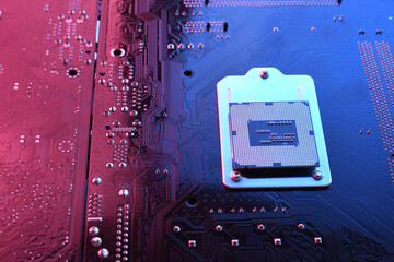 Computer cpu processor chip on circuit board ,motherboard background. Close-up. With red-blue lighting