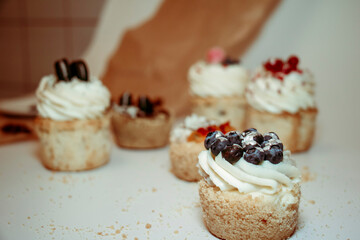 
Different types of muffins with cream and fillings on a white background