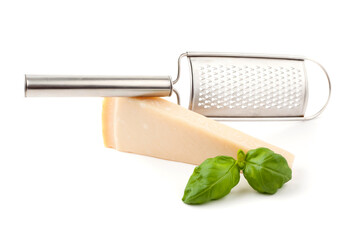 A shredder and one piece of parmigiano cheese. Studio photo isolated on white background.