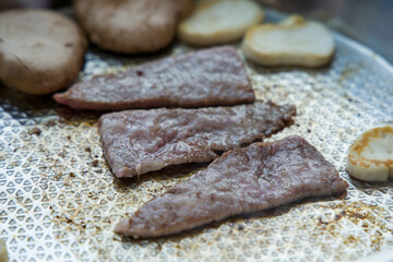 Grilled Korean beef cooked on a stainless steel frying plate