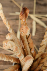 Grissini on the wooden table. Traditional italian snack with herbs. 