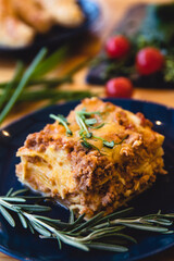 Piece of tasty hot lasagna with red wine.