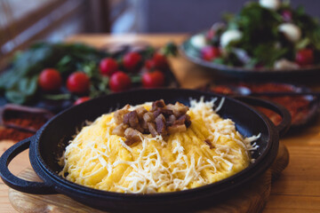 banosh, a traditional Ukrainian corn grain dish with fat and sheep cheese. style rustic. 