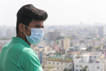  young man with protective face mask at city 