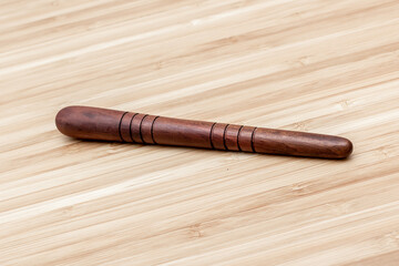 Massage wooden stick for reflexology and spa therapy. Tool. On bamboo background. Su jock.