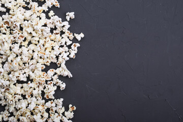 Salted popcorn on a concrete, stone background. Top view